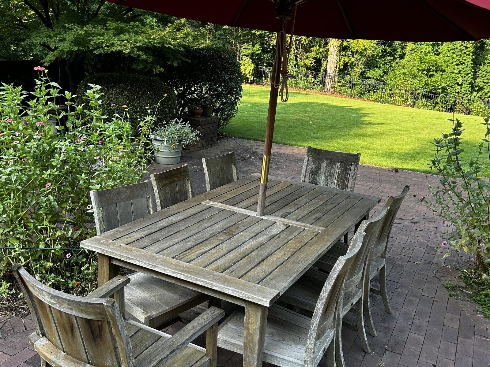 Weathered teak dining table and chairs, before